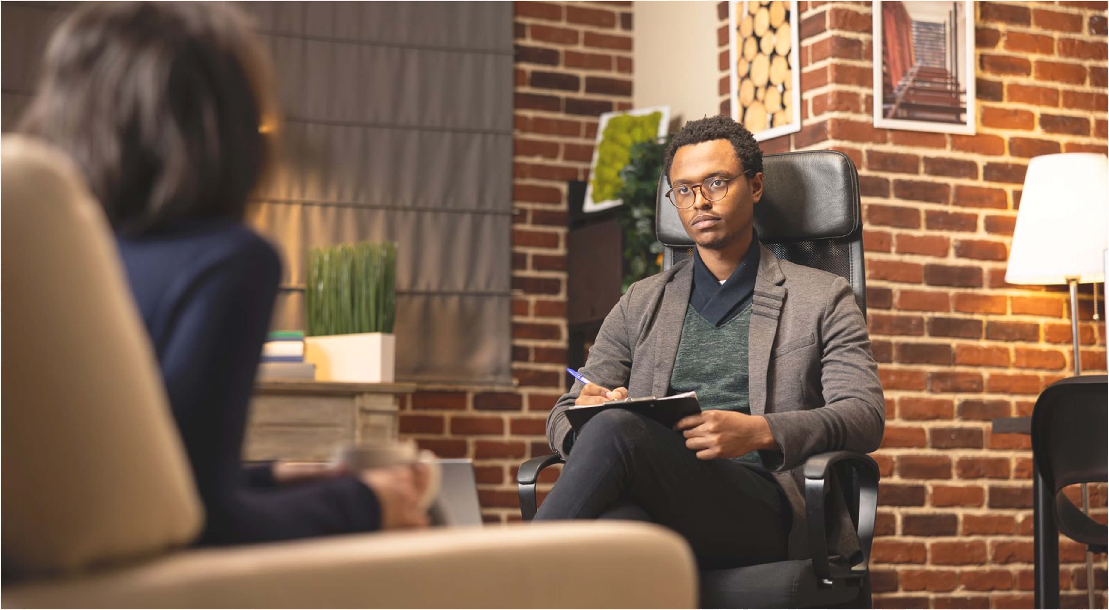 Confident woman seated indoors with warm lighting